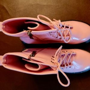 Pink vinyl combat boots.
